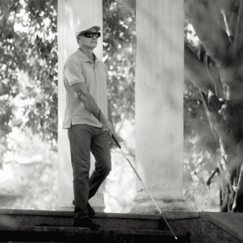 Blind Man walking with a cane.