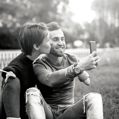 Two people with physical disabilities taking a selfie.