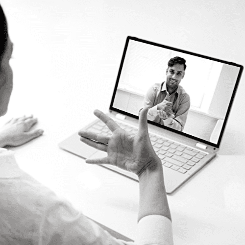 A woman and a man using a video call using sign language.