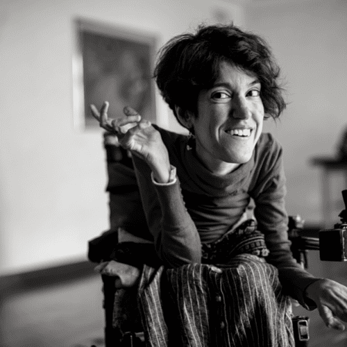 Woman with disability smiling at the camera.