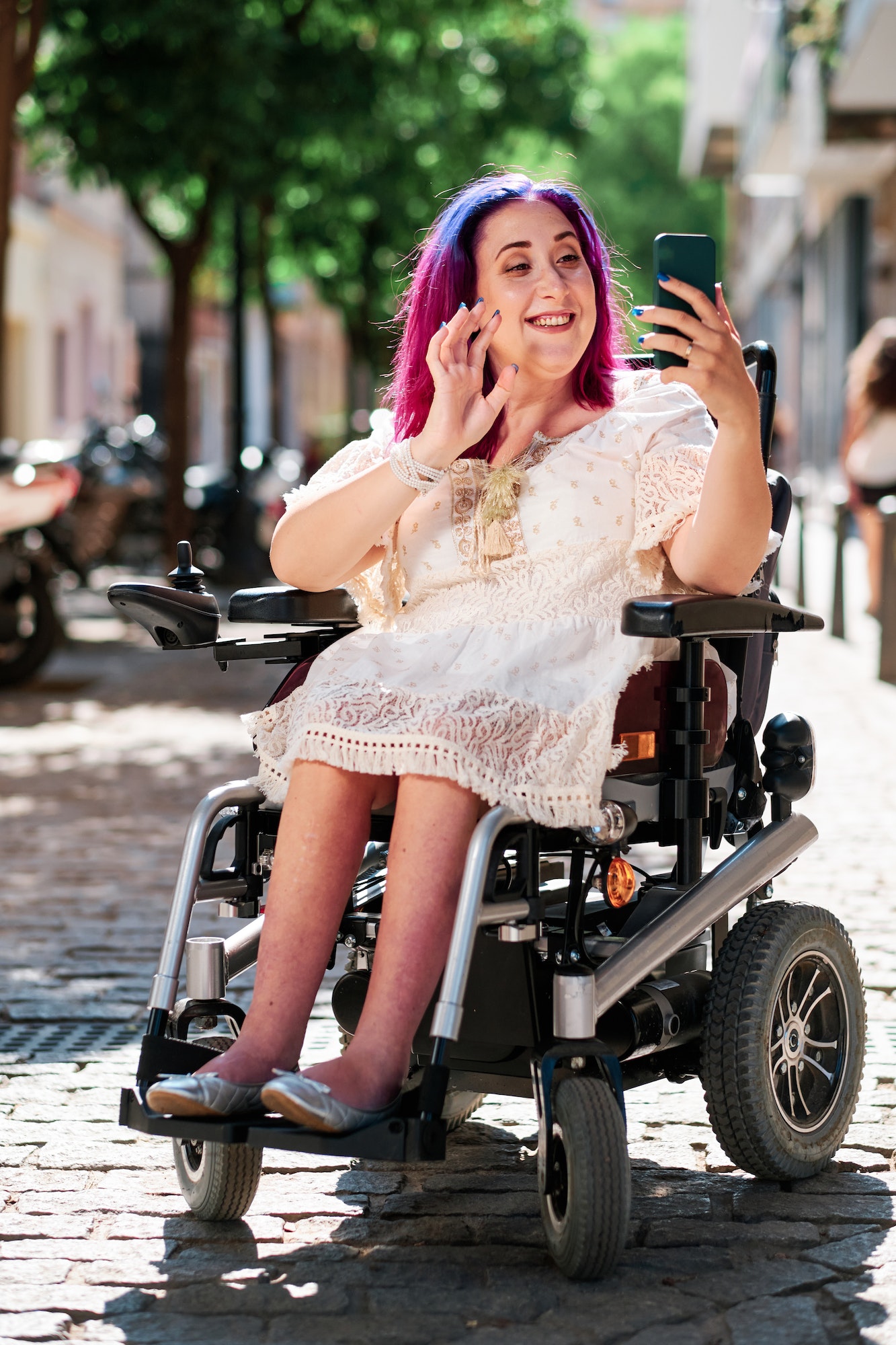 adult caucasian woman with disabilities using smartphone for streaming - videoconference